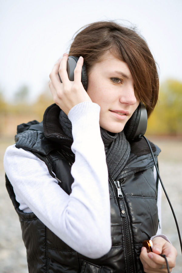 young person listening to headphones