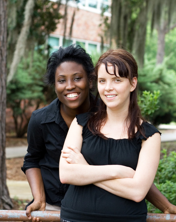 two young friends at school leaning on bike rack