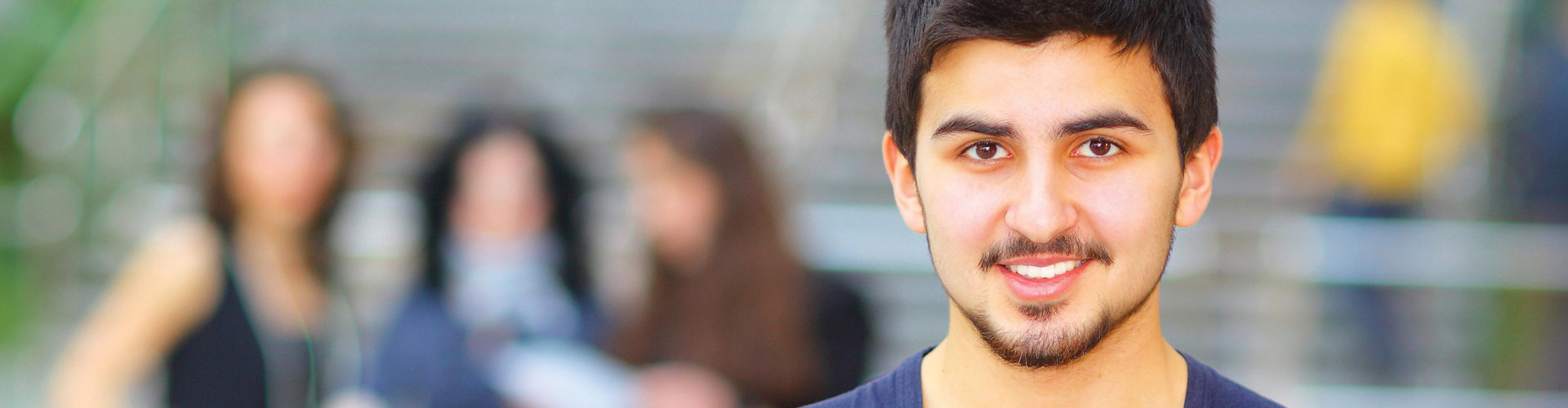 Portrait of smiling young college student holding notebook